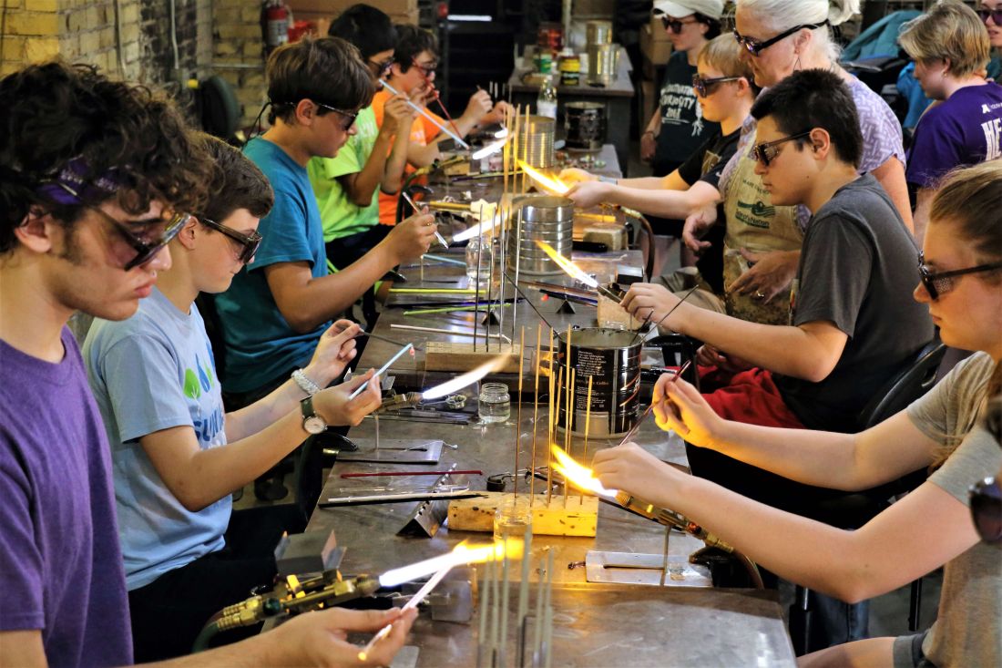 Youth engaging in metal and fire arts