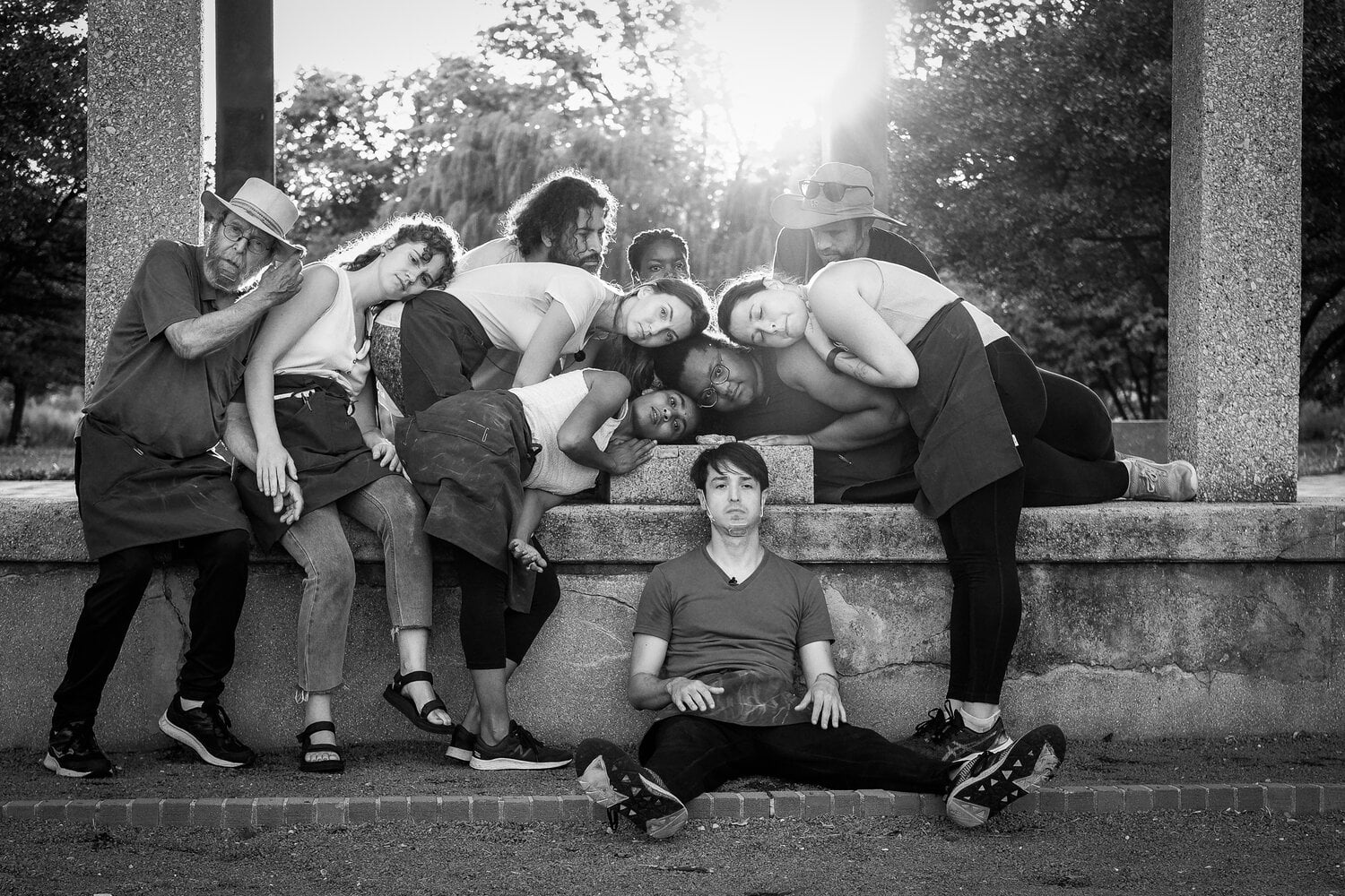Black and white image of Theater Y performers leaning on each other 