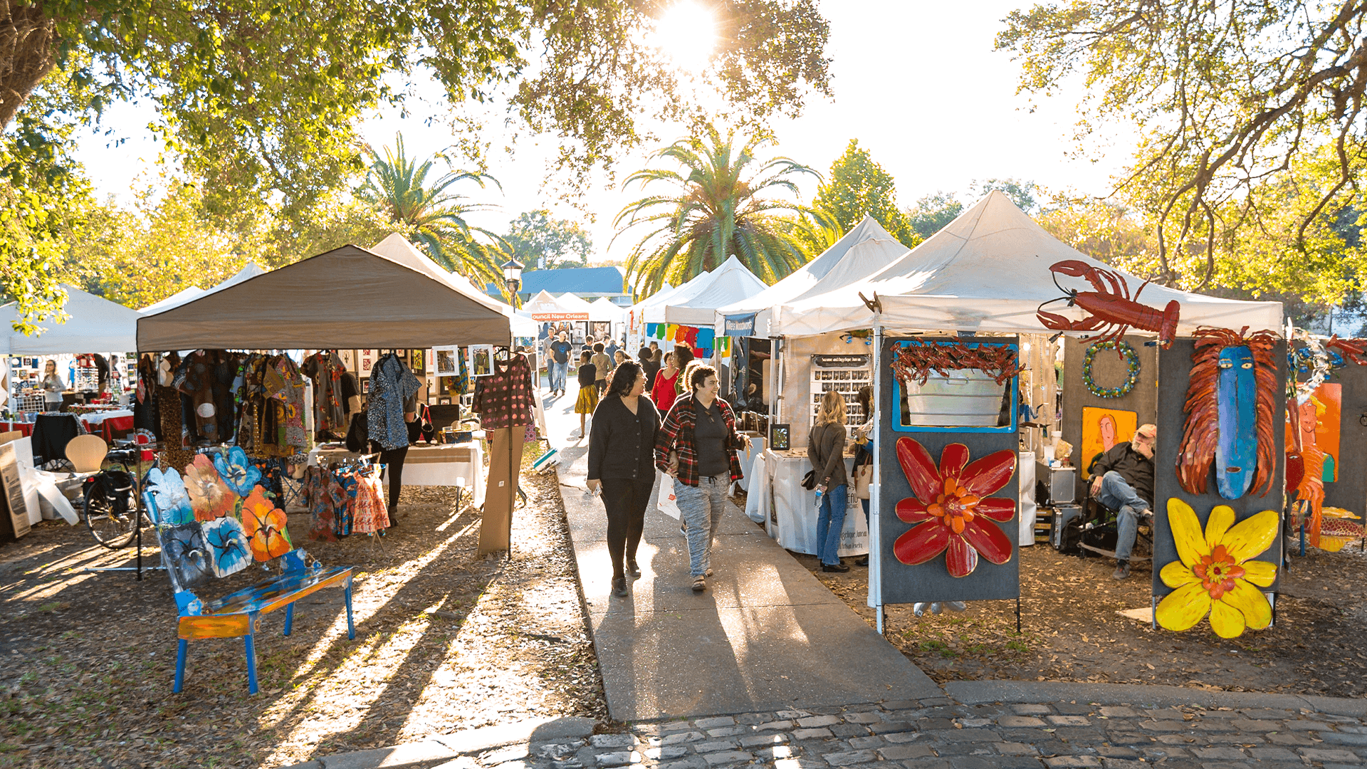 New Orleans community members walking through an outdoor art fair