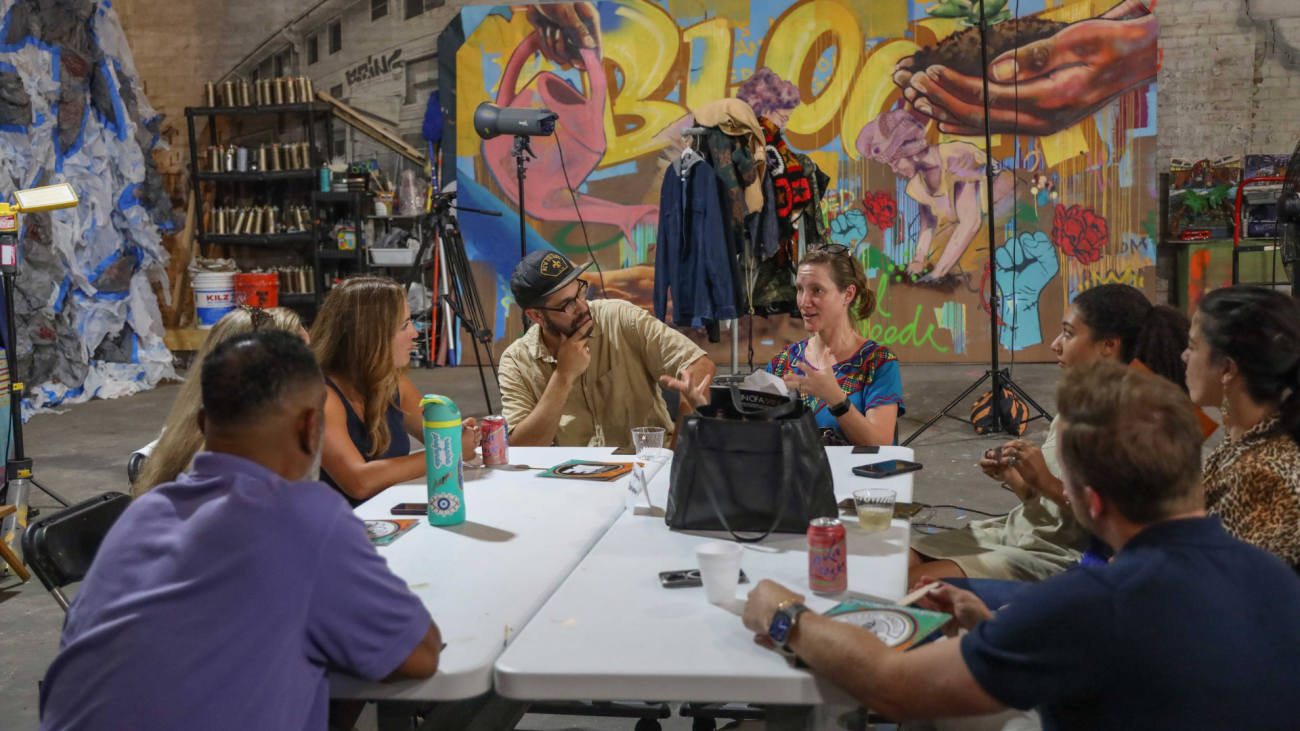 Cohort members talking around a table