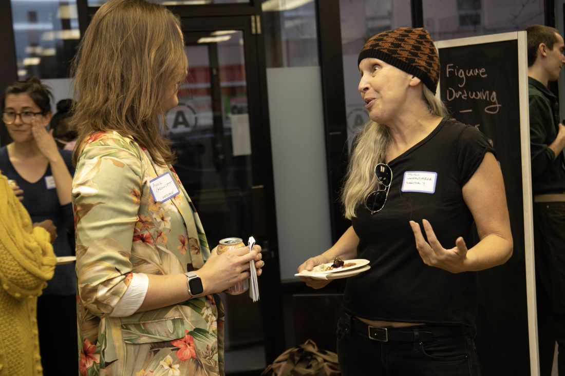 Chatting casually with drinks and hors d'oeuvres.