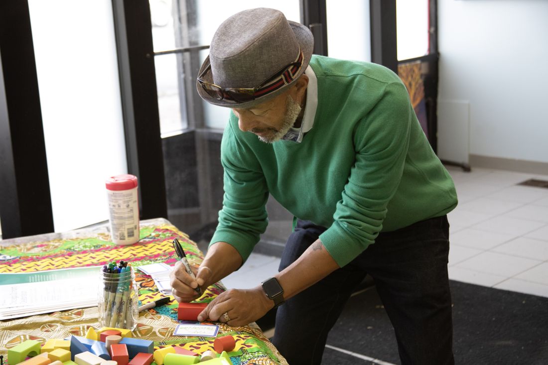 Attendee writing on a building block.