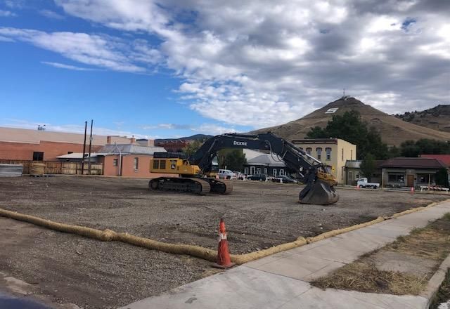 Empty lot with heavy machinery after building demolition at 1st and D Streets