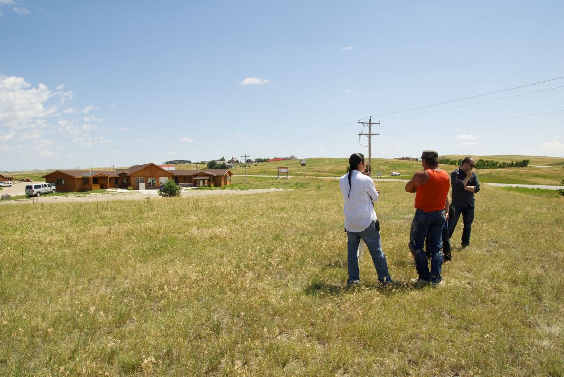 Beautiful open plains with people touring the future site.