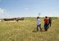 Beautiful open plains with people touring the future site.