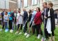 Group of people lined up to first break ground with new shovels.