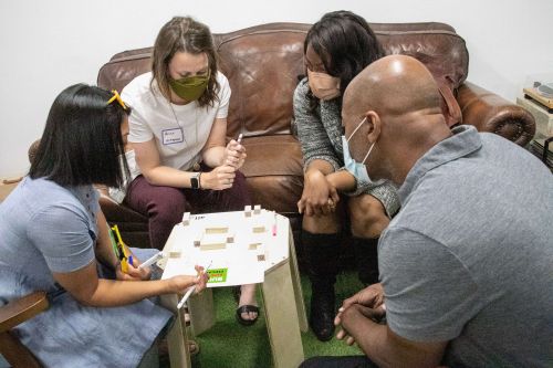 Immersion cohort participants engaged in an activity around a table