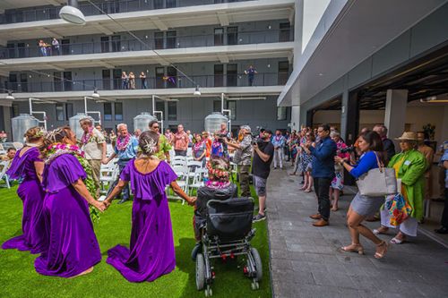 people holding hands at the Hawaii grand opening