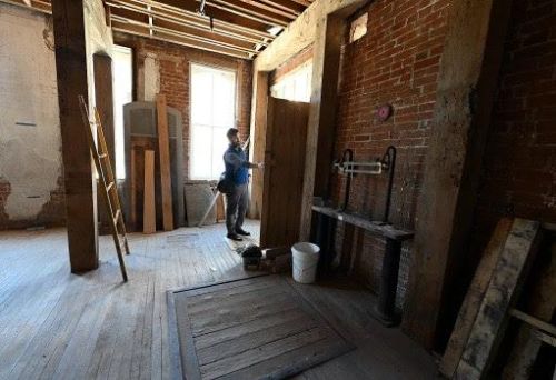 Lucas Koski, director of property development for Artspace, opens the door leading to the outdoor space in one of the units under construction