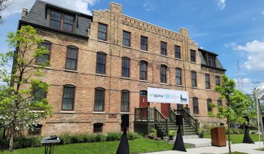 Brick exterior of Pullman Artspace Lofts against a blue sky