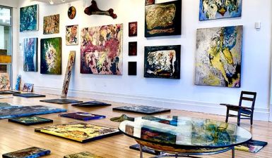 Gallery view - white walls and colorful, abstract art pieces