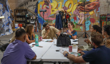 Cohort members talking around a table