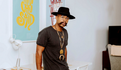 Photo of artist with hat and distinct mustache