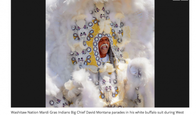 Washitaw Nation Mardis Gras Indian Big Chief David Montana parades in his white buffalo suit