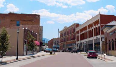The main street of Trinidad, Colorado, with brick buildings and a sunny sky
