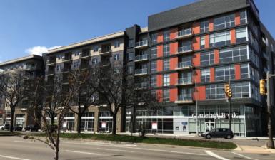 The glass exterior of a mixed housing complex in Detroit