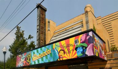 the Art Deco sandstone exterior of the Ambassador Theater, photographed as a new colorful mural marquee is unveiled