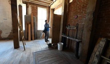 Lucas Koski, director of property development for Artspace, opens the door leading to the outdoor space in one of the units under construction